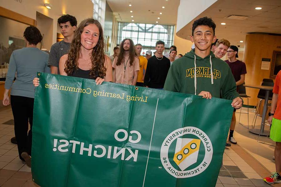 Students holding Go Knights! banner for freshman convocation